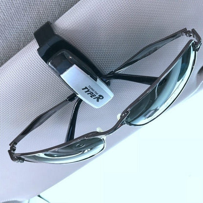 TYPER. Clip-soporte de automóvil para gafas de sol.